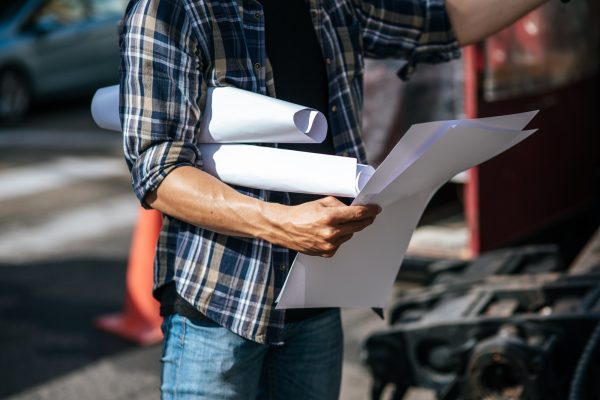 Civil engineers work on large road and machinery conditions.